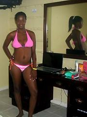 Young African girl in a pink bikini..